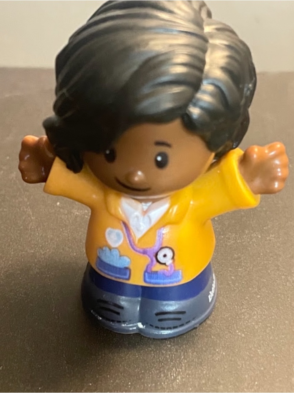 Little people doctor with black hair and brown skin